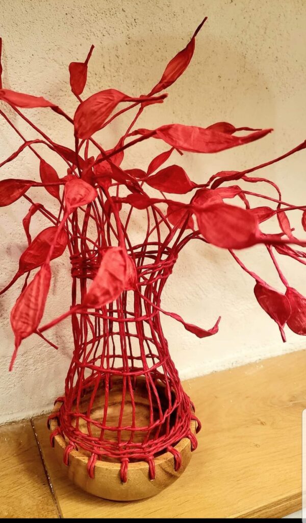 vase en fil de papier sur un fons en bois